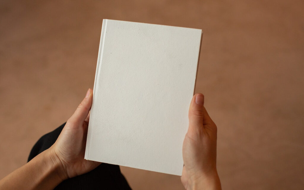 white book in hands